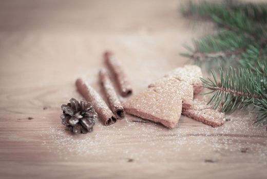 cinnamon sticks, cookies and Christmas tree branch but the table .Christmas background