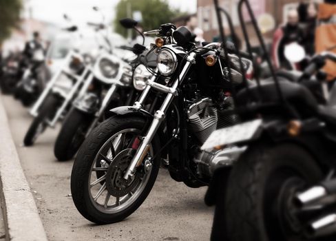 A number of motorbike bikers in the city.