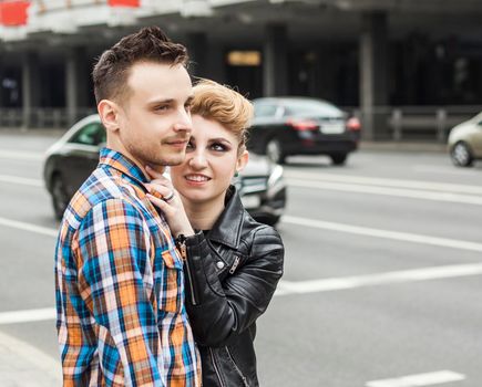 rear view: a couple in love on the streets of the big city