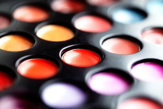 Close-up macro shot of lipgloss palette. Colourful salon cosmetics for makeup artist. Vibrant make-up product. Soft focus.