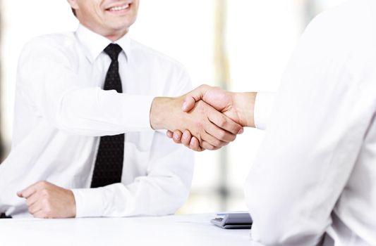 Close up image of business handshake at meeting. Partnership concept