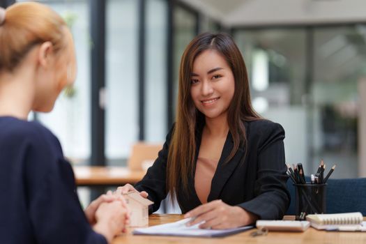 Business woman explain before signing agreement contract for buying house. Bank manager concept