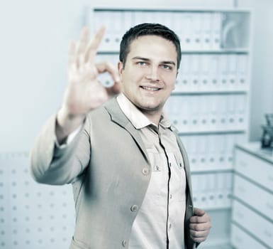 portrait of a young businessman showing OK sign.photo with copy space
