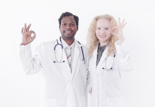 two doctors of the medical center showing OK gesture.isolated on white background