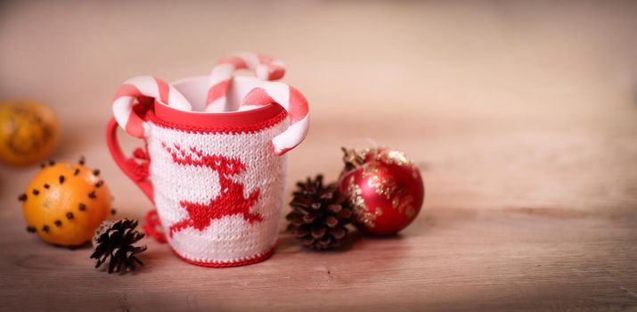 Christmas Cup and oranges on wooden background blurred.photo with copy space