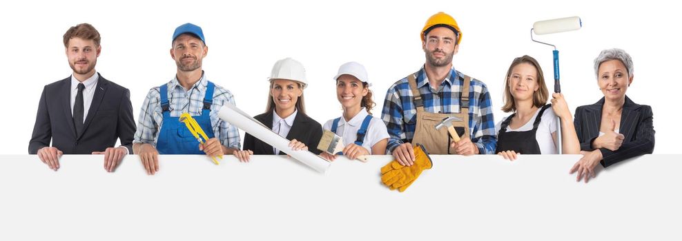 Portrait of happy construction workers holding blank billboard isolated on white background, empty copy space for text content