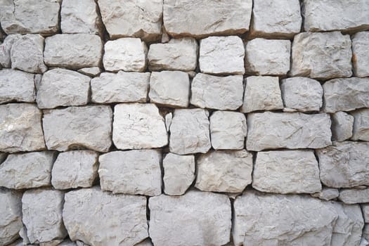 fence wall made of large rock stones.