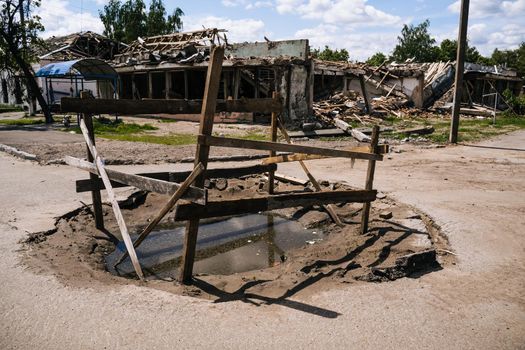 War in Ukraine. Crater from an explosion in the Sumy region. Russia's military invasion of Ukraine