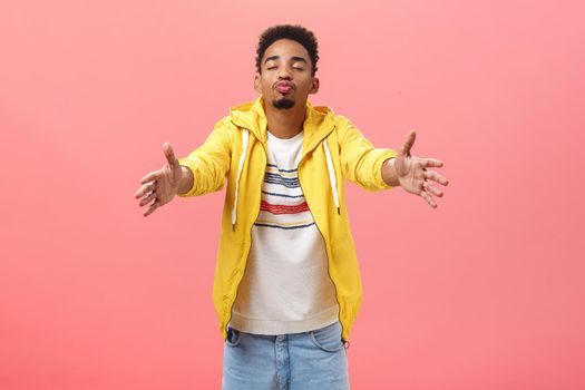 Man longing to kiss popular girl in university folding lips close eyes and pulling hands towards camera in hug gesture clinging on girlfriend wanna make out over pink background. Emotions and relationship concept