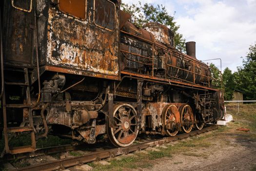 Burned-out locomotive is a museum exhibit at the railway station in the city of Trostyanets. Sumy region. Civil buildings. Russian military invasion of Ukraine