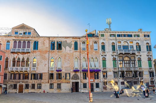 Venice, Italy, September 13, 2019: Campo San Maurizio square with Micromega Arte e Cultura MAC museum building and stone well in historical city centre San Marco sestiere, Veneto region