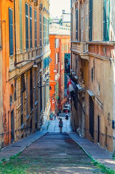 Genoa, Italy, September 11, 2018: Stairway between old buildings with colorful walls on narrow street in old quarter of historical centre of Genoa Genova city , Liguria