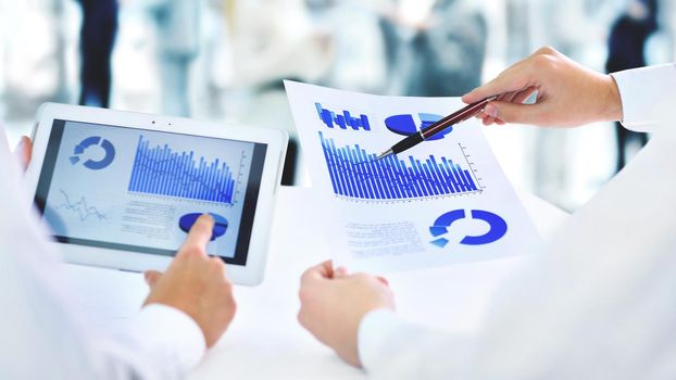 Close-up of businessman explaining a financial plan to colleagues at meeting