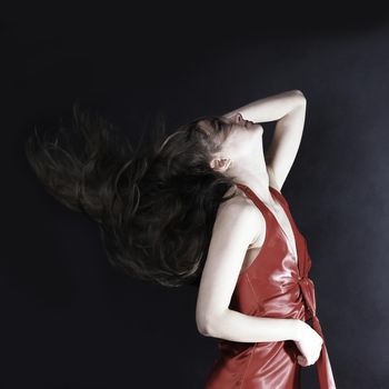 portrait of glamorous young woman in a red dress. isolated on a black background.