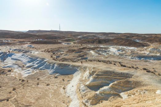 Beautiful lunar landscape. Wight and smooth hills in various shapes in a desert landscape. The whitish, rounded, winding, and smooth chalk rocks. Israel. High quality photo