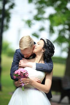 Bride and groom at wedding Day walking Outdoors on spring nature. Bridal couple,