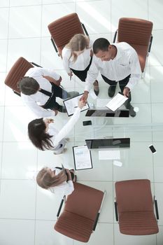 top view.the handshake business partners at a business meeting.photo with copy space