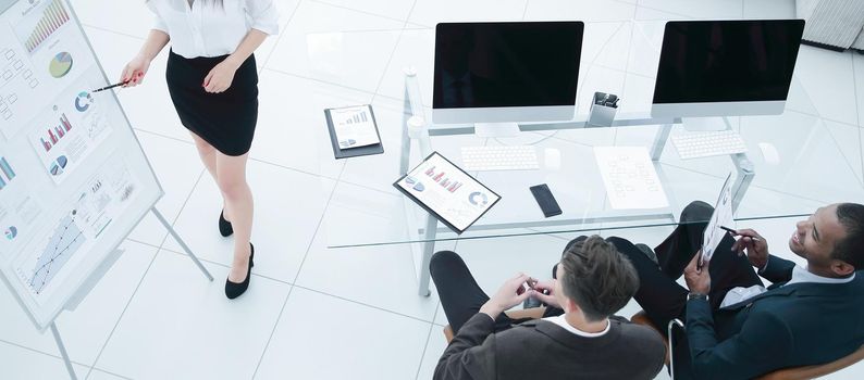 young business woman making a presentation to his business team in a modern office