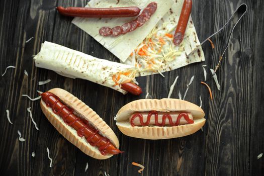 fast food.sausage in pita bread and hot dog on wooden background.