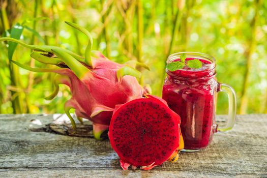 Dragon fruit smoothie on a wooden background.