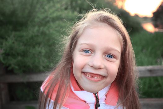 portrait of a little girl on the background of the Park.