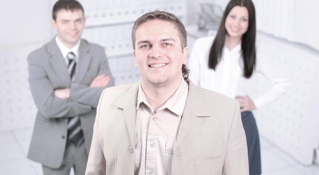 confident young businessman on background of office.photo with copy space