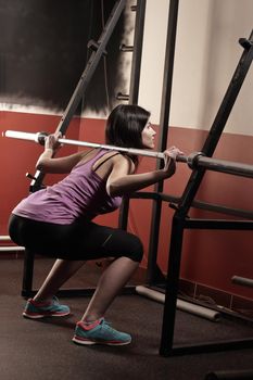 Beautiful girl doing exercises on the simulator in the gym.photo with copy space