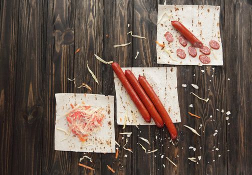 sausages and salad on pieces of lavash.photo with copy space.