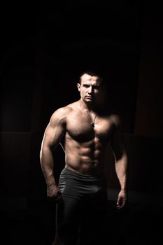 Portrait of a brutal bodybuilder on a black background