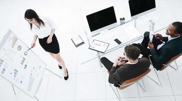 young business woman making a presentation to his business team in a modern office