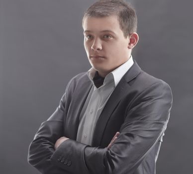 stylish young man in a gray suit.isolated on grey.
