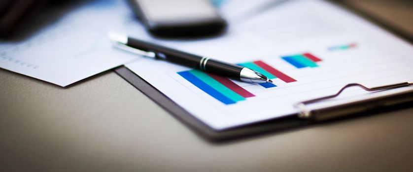 financial charts and graphs on the table in office