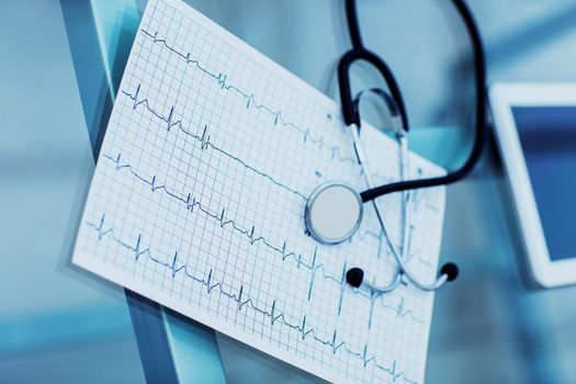 stethoscope and electrocardiogram on the table from the therapist.the photo is a blank space for your text