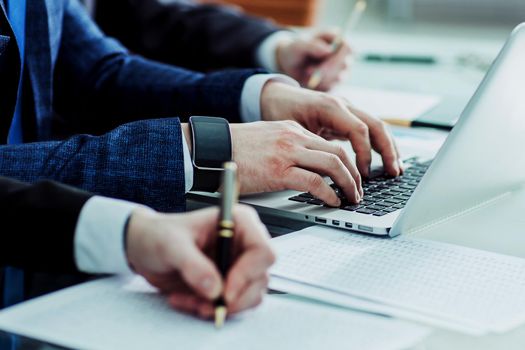 business team conducting analysis of marketing reports at the workplace in the office.the photo has a empty space for your text