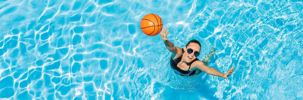 Young woman plays in the pool with a beach ball. BANNER, LONG FORMAT