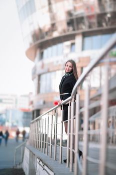 confident business woman against a modern office building. Photo has empty space for your text