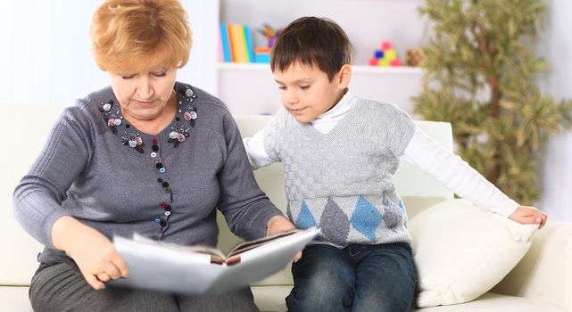 Grandmother and grandson reading a book