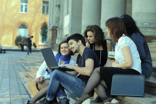group of fellow students with books and laptop.education concept