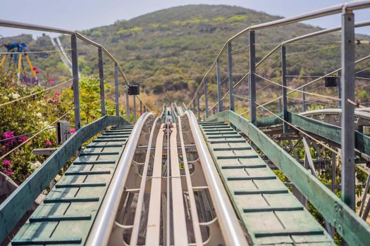 Rail downhill on a trolley, Point of view during a ride on Alpine Coaster on rails.