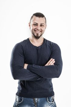 sporty guy - bodybuilder in jeans and a t-shirt on a white background . the photo has a empty space for your text