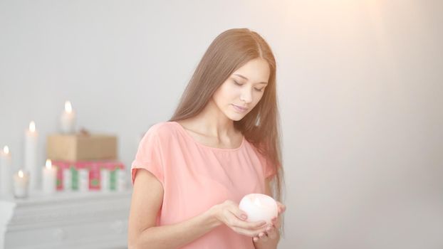 portrait of a thoughtful young woman with a candle.