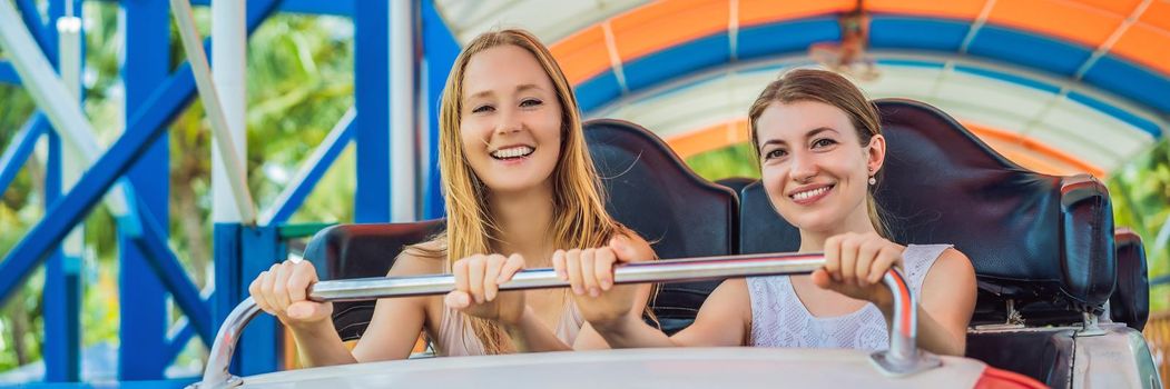 Happy friends in amusement park on a summer day. BANNER, LONG FORMAT