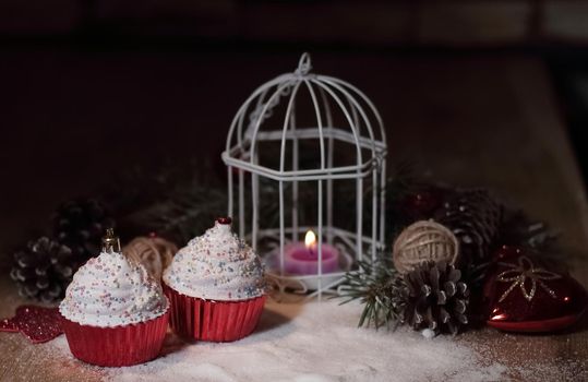 cupcakes,Christmas candle and Christmas decorations on wooden background .photo with copy space