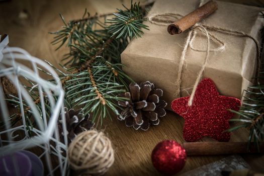 Christmas gift,cinnamon sticks and Christmas decoration on wooden background