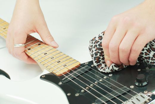 closeup.rock guitarist,wiping the neck of the guitar .photo with copy space