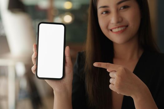 A Woman excited surprise and showing cell phone screen. Blank screen for your advertising