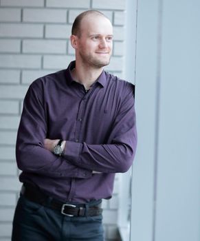 pensive businessman looking out office window.business people