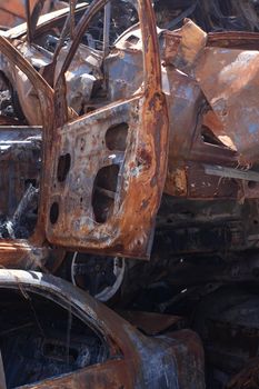 rusty burnt cars in Irpen, after being shot by Russian military and missile. Russia's invasion. war against Ukraine. Cemetery of destroyed cars of civilians who tried to evacuate from war zone.