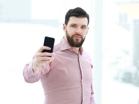 handsome man taking selfie in the office .photo with copy space