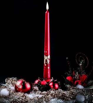 candle and Christmas composition on a black background.photo with copy space